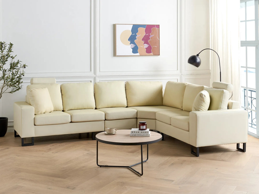 Light beige leather left‑hand corner sofa with plush cushions and modern design in a living room