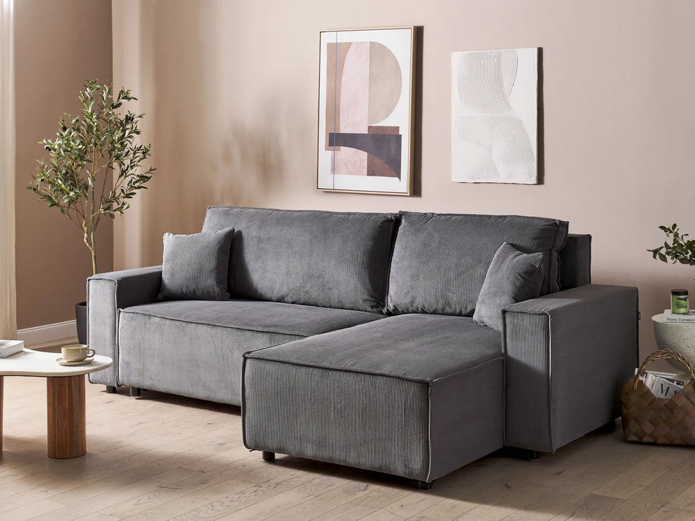 Gray sectional sofa in a living room with decorative elements.