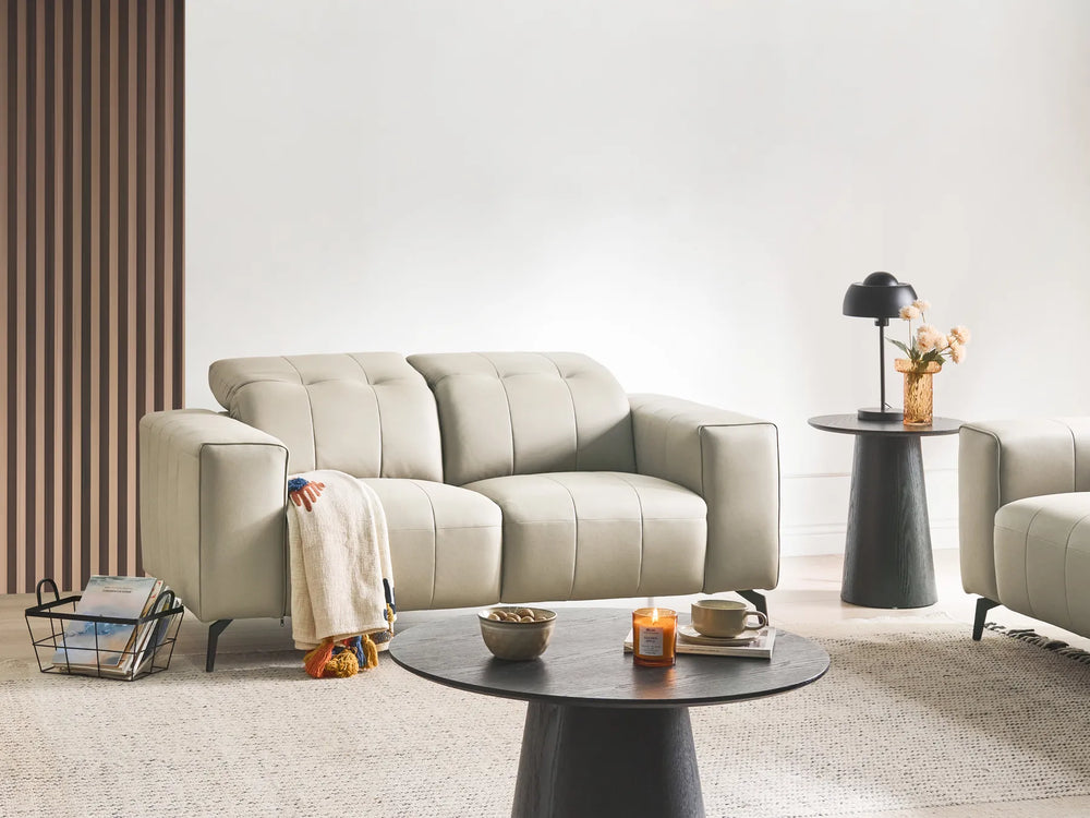 Modern living room with a beige sofa, coffee table, and side table.