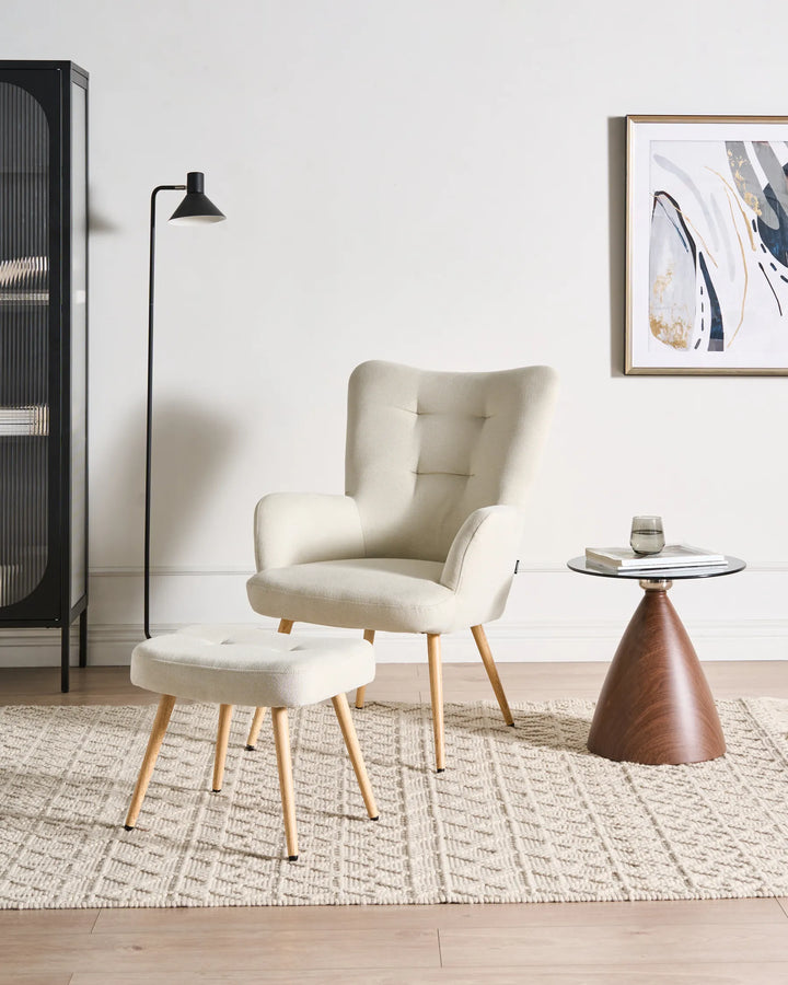 Modern living room with a beige armchair, side table, and abstract art on the wall.
