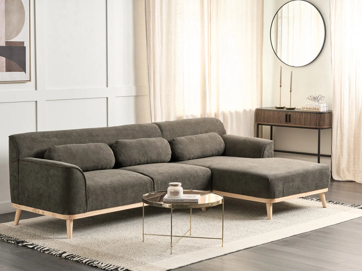 sectional sofa in a living room setting with a coffee table and decorative items.