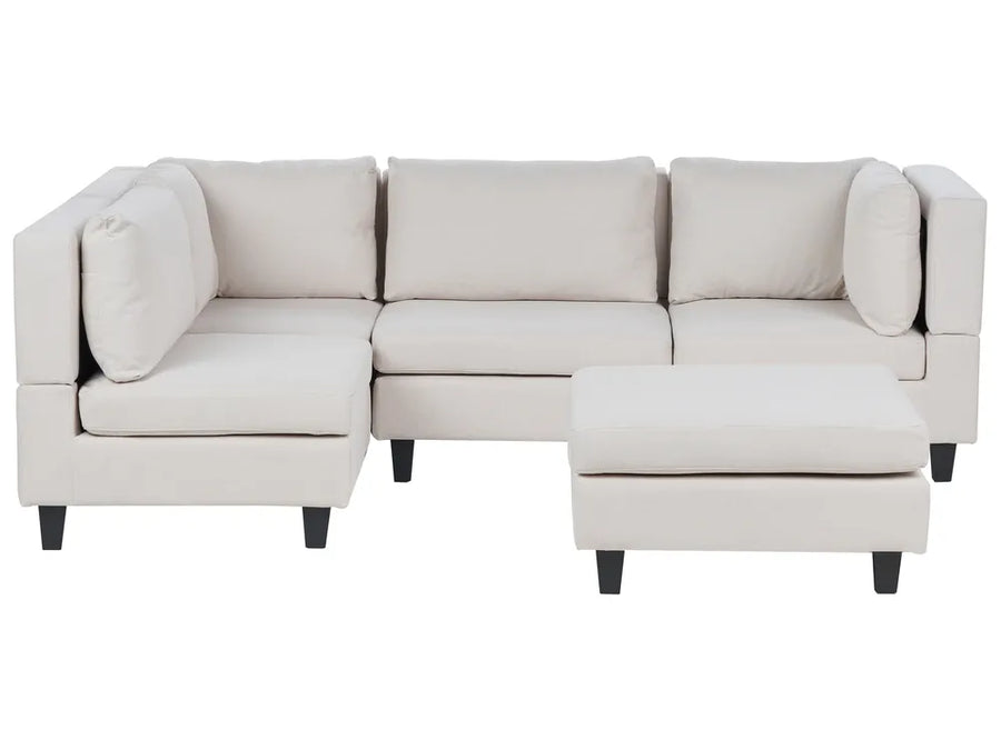 Beige sectional sofa with ottoman on a white background