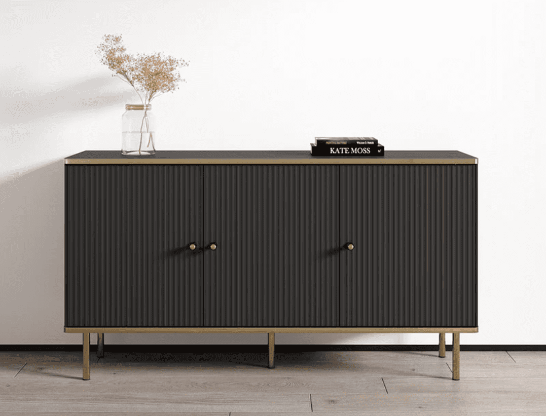 Dark wooden sideboard with gold accents on a light wood floor against a white wall.