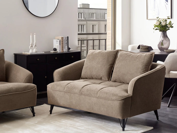 Beige sofa in a living room setting with a modern decor.