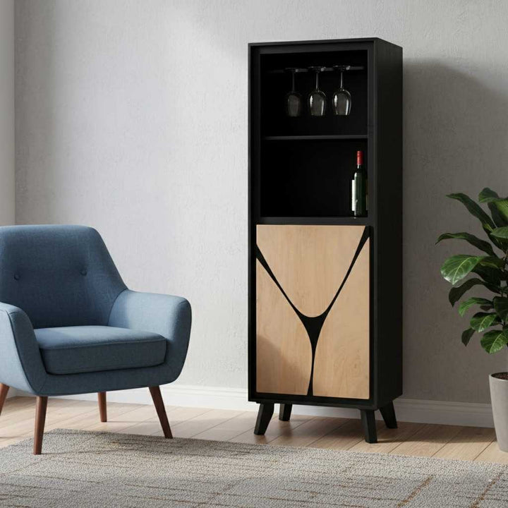Tall black and wood cabinet with wine bottles and glasses in a room with a blue armchair and plant.