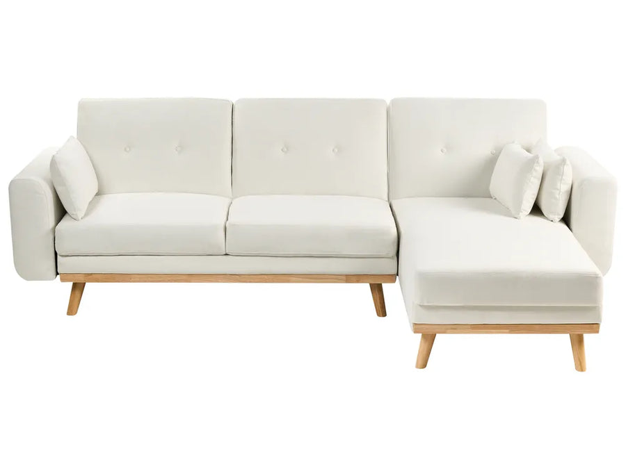 White sectional sofa with wooden legs on a white background