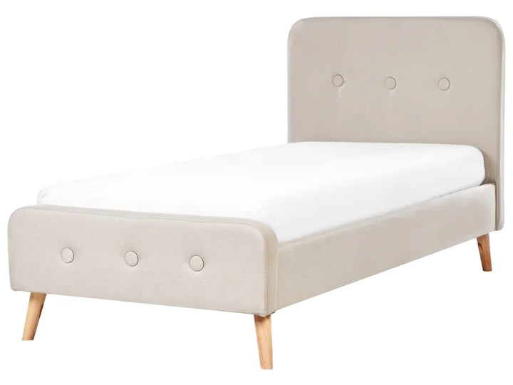 Beige upholstered bed with white mattress on a white background