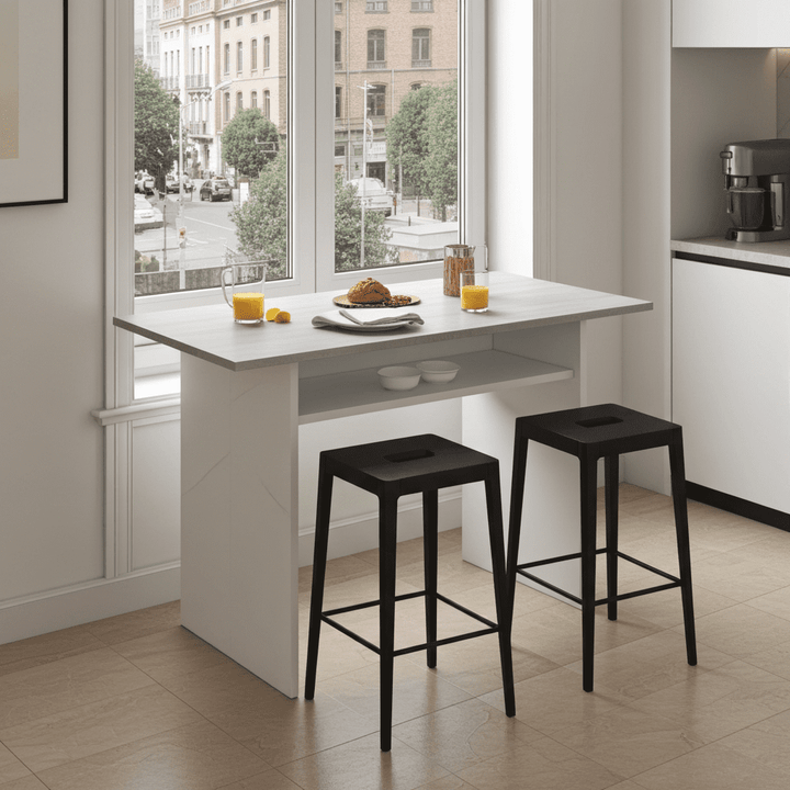 Modern kitchen with a white breakfast bar and black stools, cityscape visible through window.