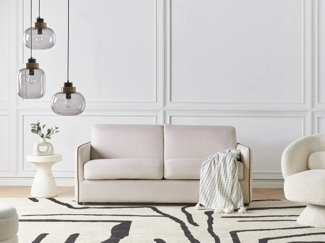 Modern light beige fabric sofa bed with cushioned seat and backrest