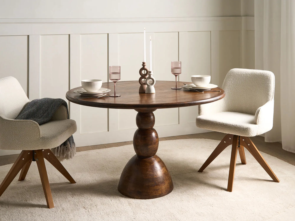 Dining room with wooden table and white chairs in a minimalistic setting