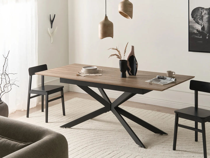 Dining table with black metal legs in a modern living room setting