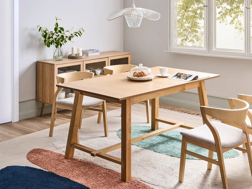 Dining room with wooden table and chairs, sideboard, and decorative elements.