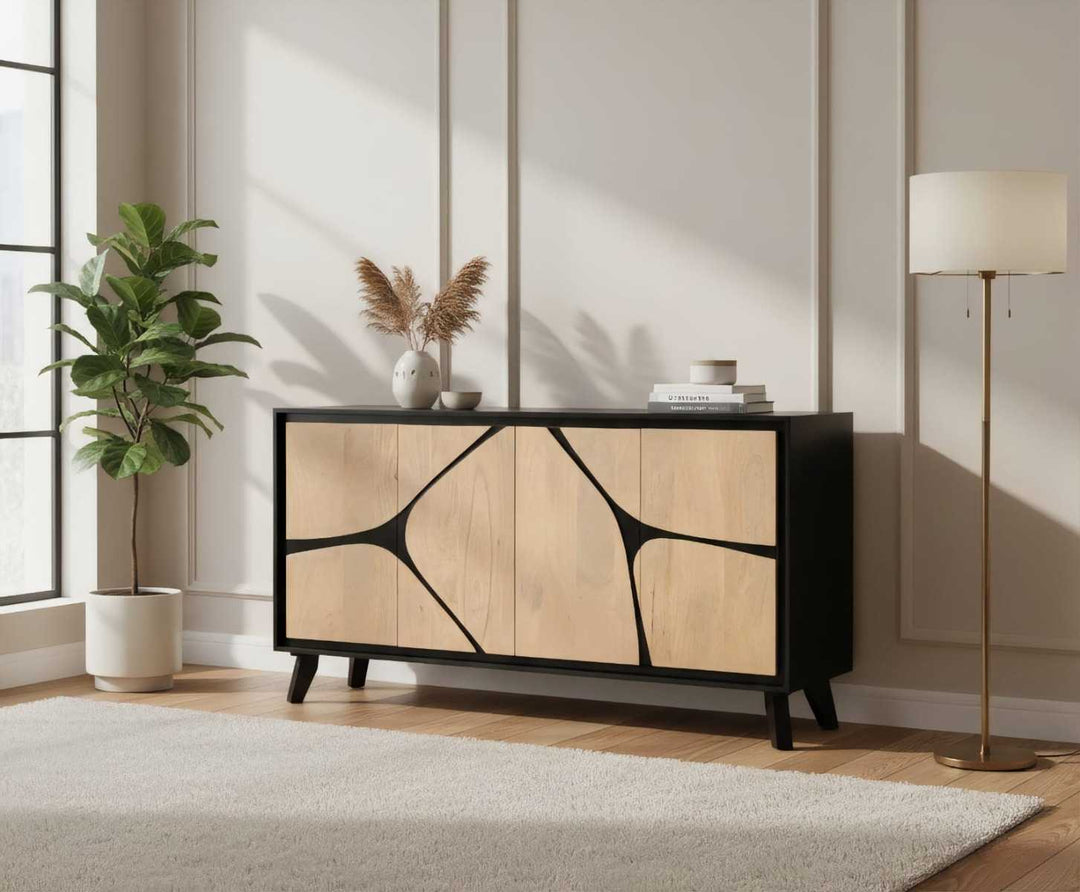 Modern sideboard with abstract design in a room with a plant and lamp.