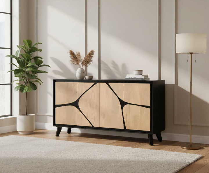 Modern sideboard with abstract design in a room with a plant and lamp.