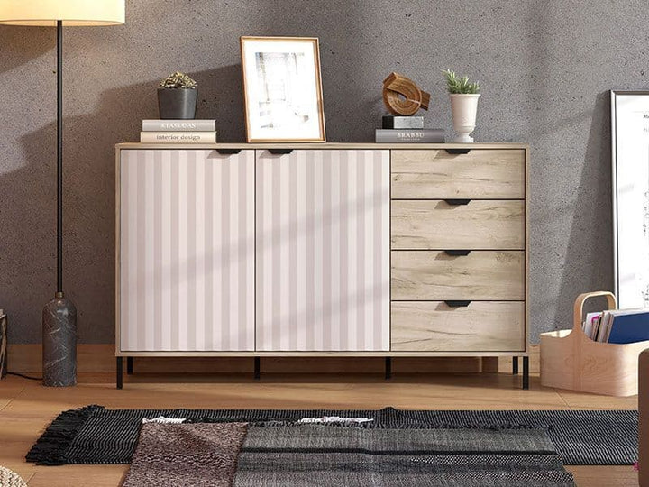 Wooden sideboard with drawers and doors against a gray wall.
