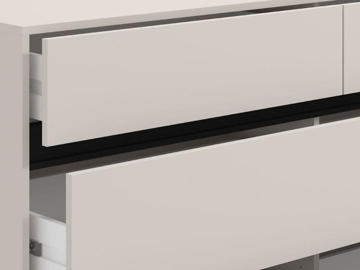 Close-up of a modern kitchen cabinet with a drawer open, showing a light gray finish.