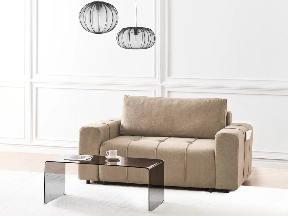 Beige sofa in a modern living room with a coffee table and decorative lamps.