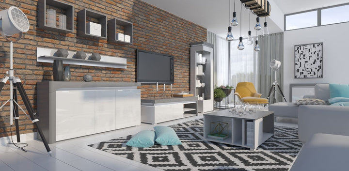 Modern living room with gray furniture, brick wall, and decorative elements.