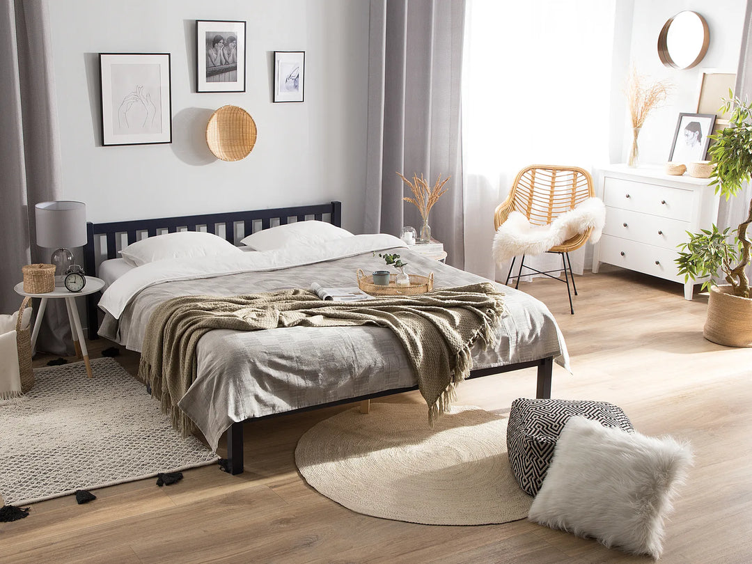 Modern bedroom with a bed, side tables, and decorative items.