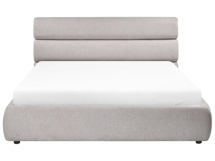 Gray upholstered bed with white mattress on a white background