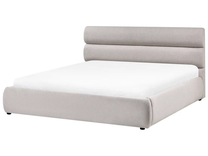 Modern bed with light gray upholstered headboard on a white background