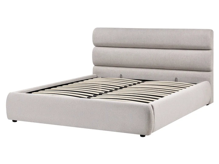 Beige upholstered bed with a tufted headboard on a white background
