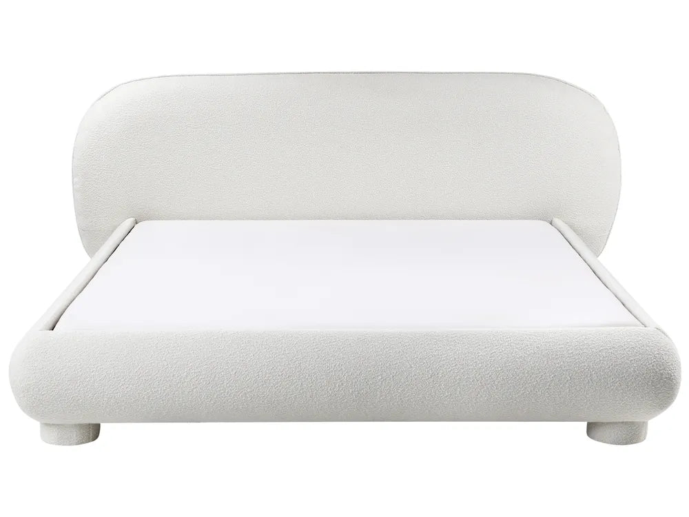 White upholstered bed with rounded design on a white background
