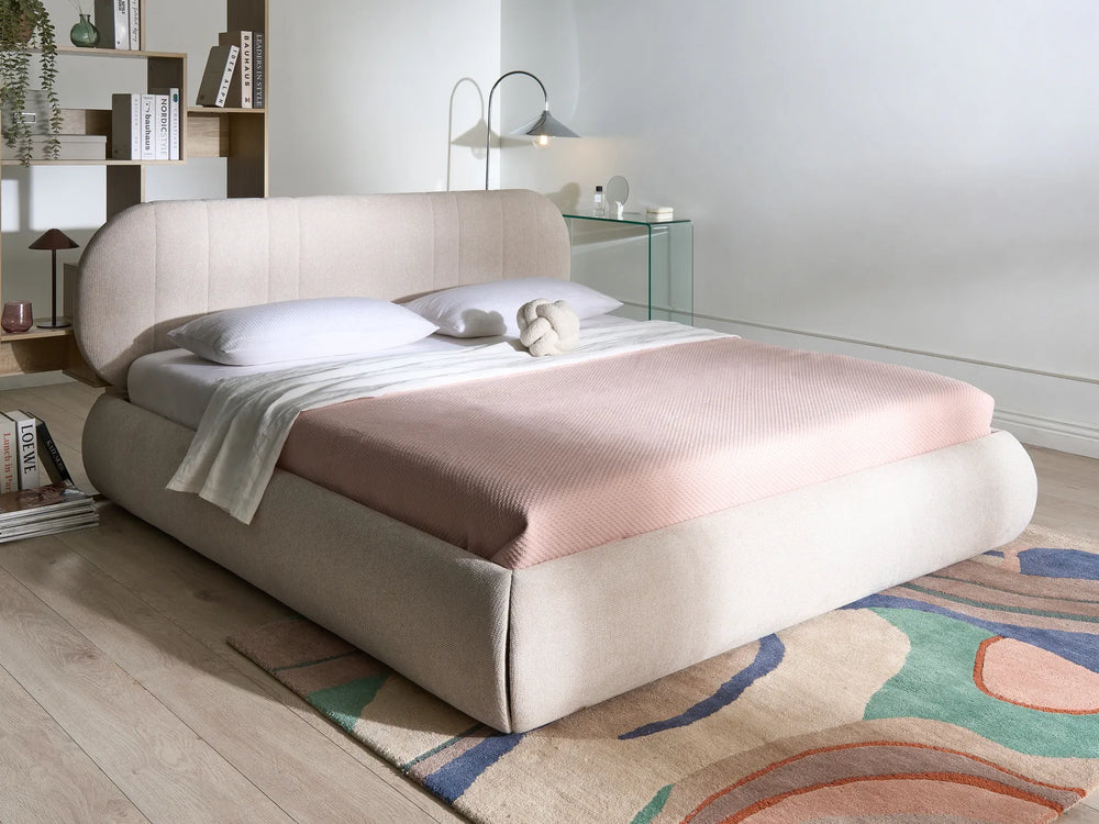 Modern bedroom with a bed, nightstands, and decorative elements.