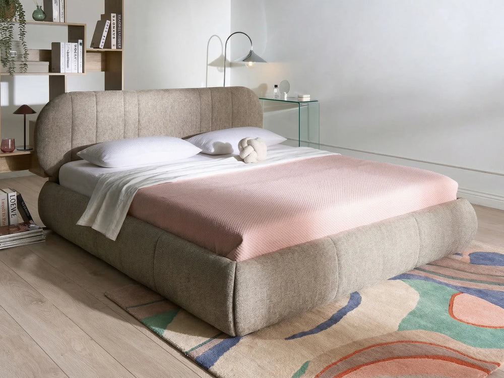 Modern bedroom with a bed, nightstands, and decorative elements.