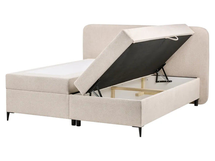 Beige upholstered bed with storage compartment on a white background