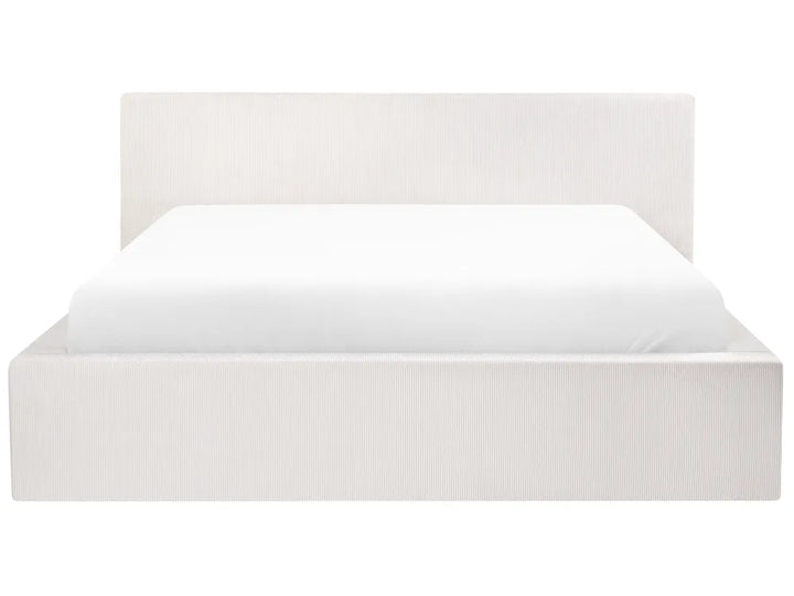White bed frame with white mattress on a white background