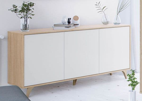 Light wood sideboard with white doors in a minimalistic room.