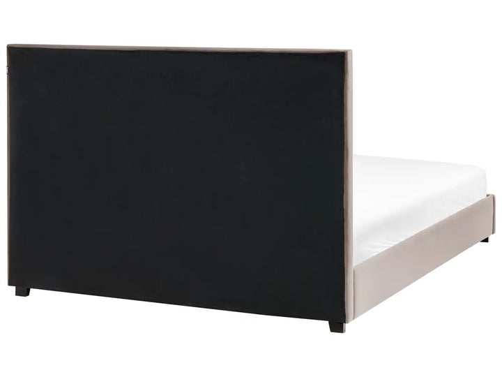 Bed with a black headboard on a white background