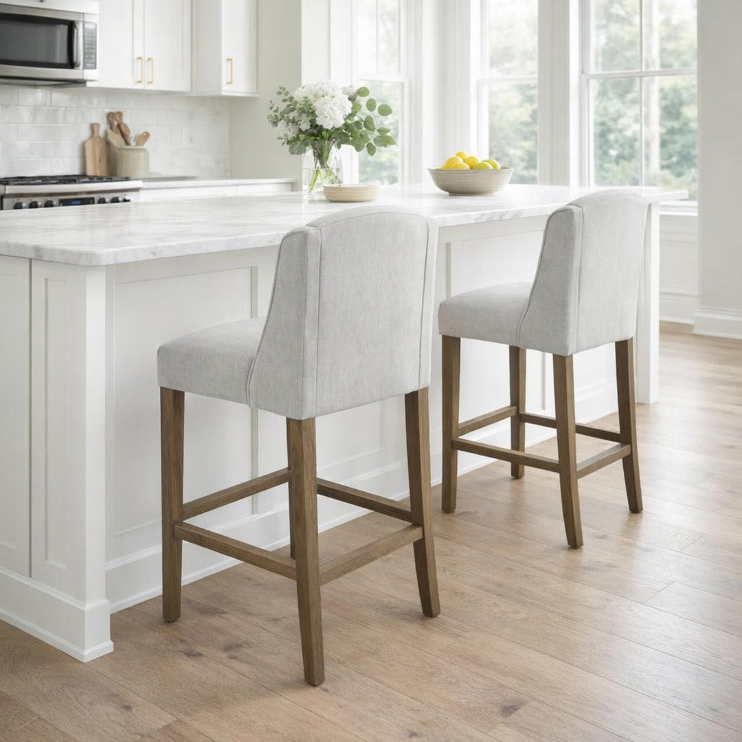 White bar stools with wooden legs in a modern kitchen.