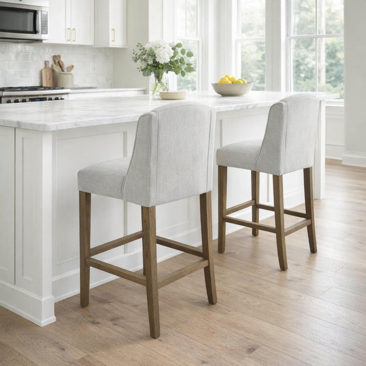 White bar stools with wooden legs in a modern kitchen.