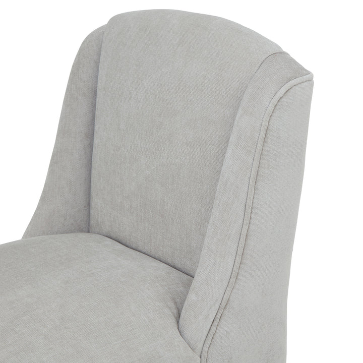 Gray upholstered chair with a white background