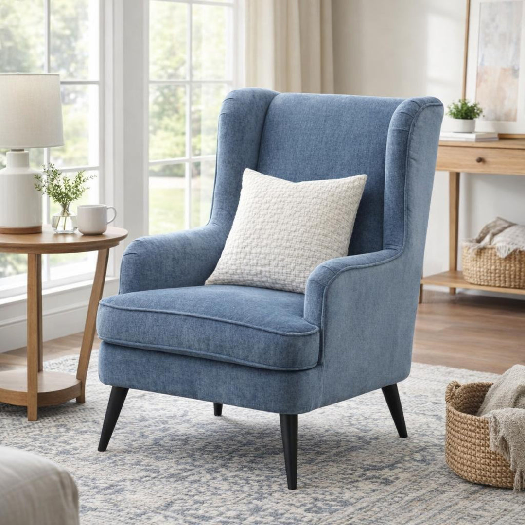 Blue armchair with a white pillow in a living room setting