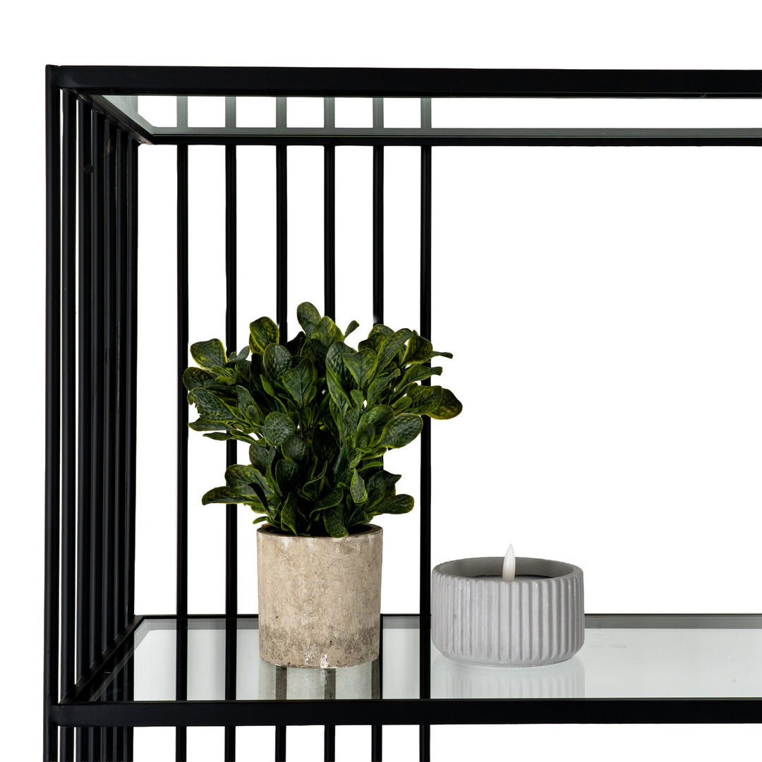 Black metal bookshelf with decorative items