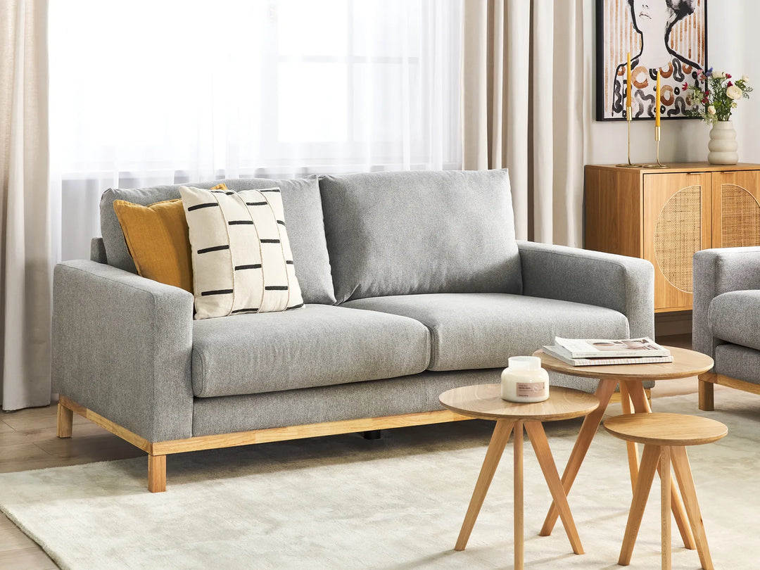 Gray sofa with wooden legs in a living room setting