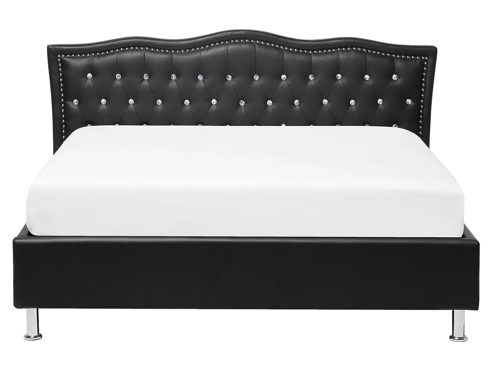 Black tufted bed frame with white mattress on a white background