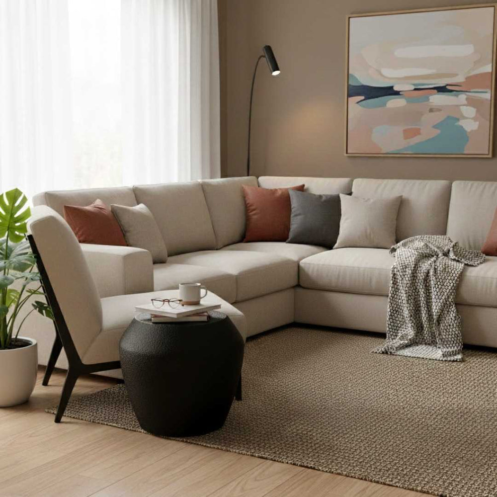 Modern living room with a beige sectional sofa, coffee table, and abstract art on the wall.