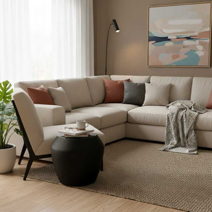 Modern living room with a beige sectional sofa, coffee table, and abstract art on the wall.