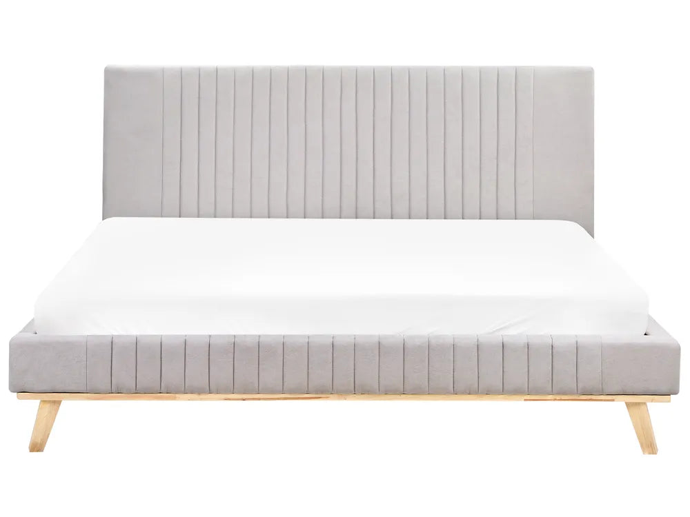 Gray upholstered bed with wooden legs on a white background