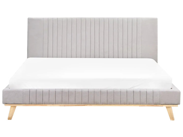 Gray upholstered bed with wooden legs on a white background