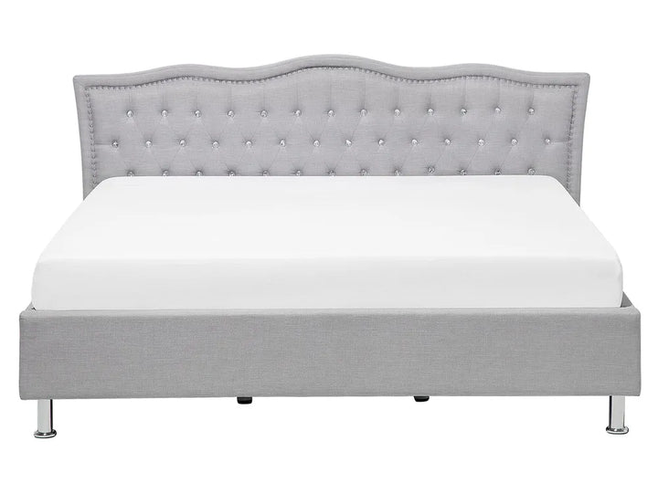 Gray upholstered bed with tufted headboard on a white background
