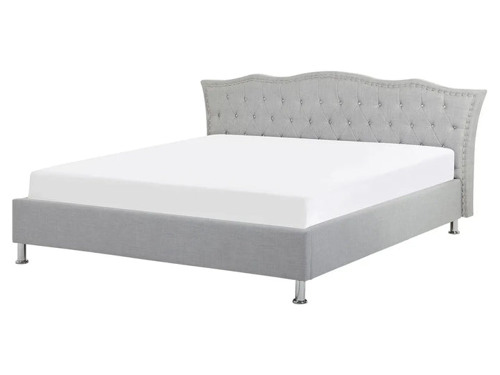 Gray upholstered bed with tufted headboard on a white background