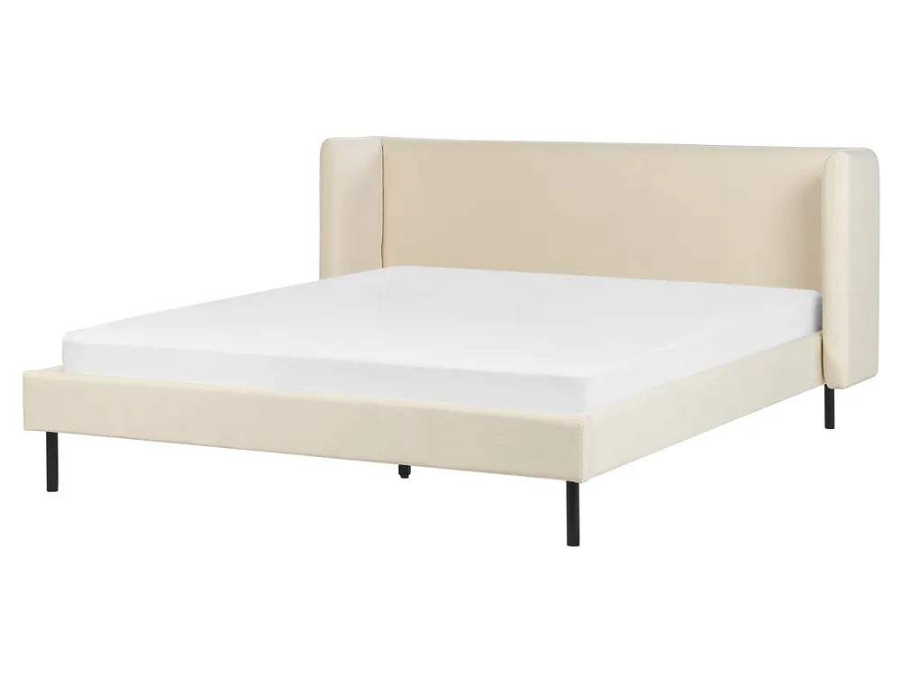 Beige upholstered bed frame with white mattress on a white background