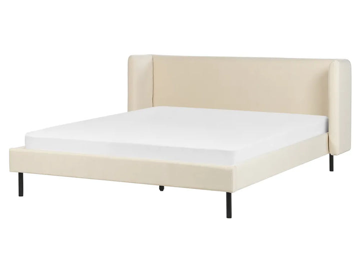 Beige upholstered bed frame with white mattress on a white background
