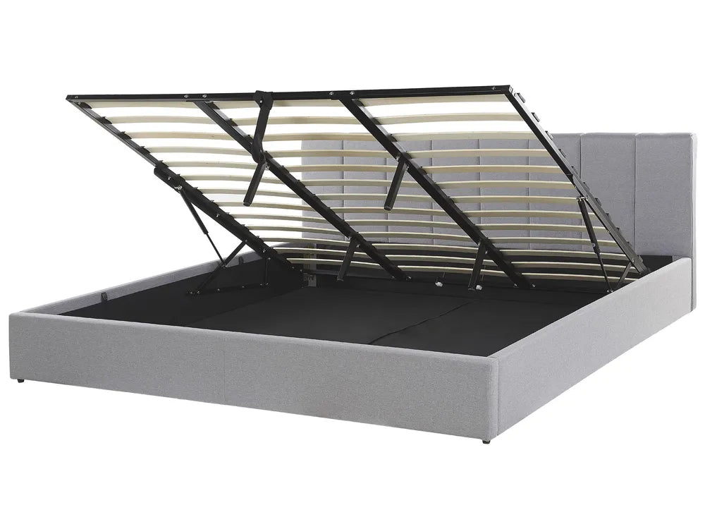Gray upholstered bed frame with a metal headboard on a white background