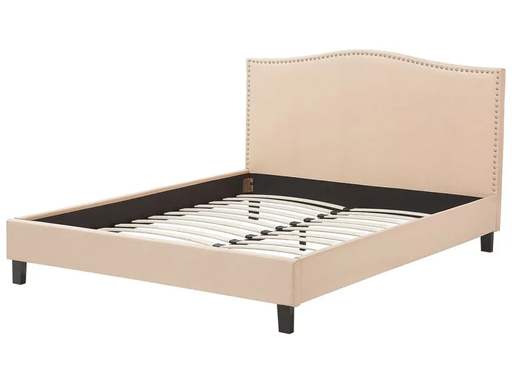 Beige upholstered bed frame with nailhead trim on a white background